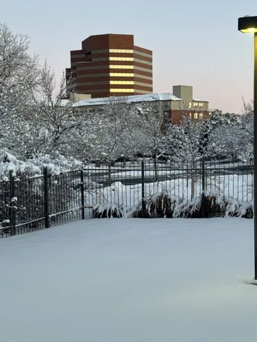 Commercial snow removal at dusk in Parker, Colorado