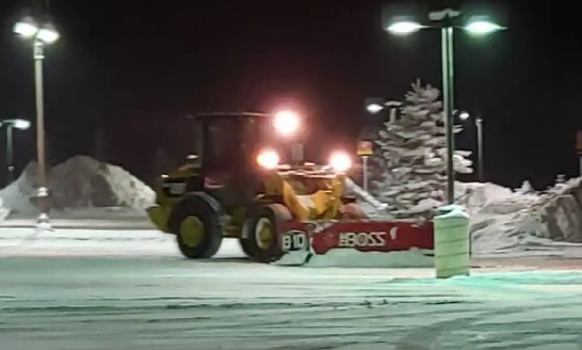Snow removal service in progress at a Denver commercial site