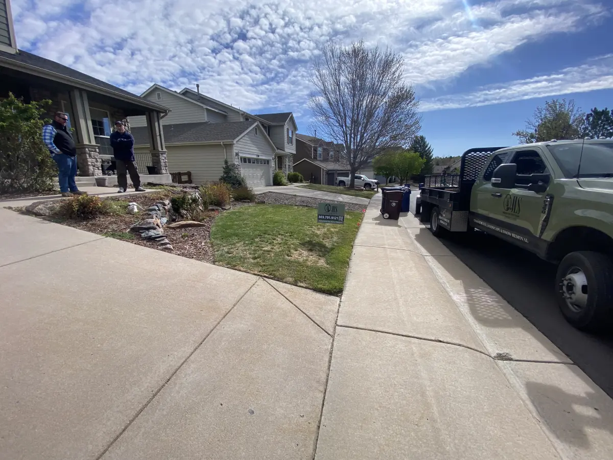 JLS Landscape crew with branded truck at a residential property